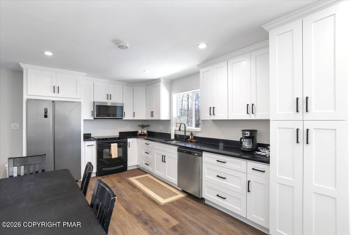 5873 Decker Road Bushkill, PA 18324 - Photo 3 of 57 a kitchen with white cabinets and appliances