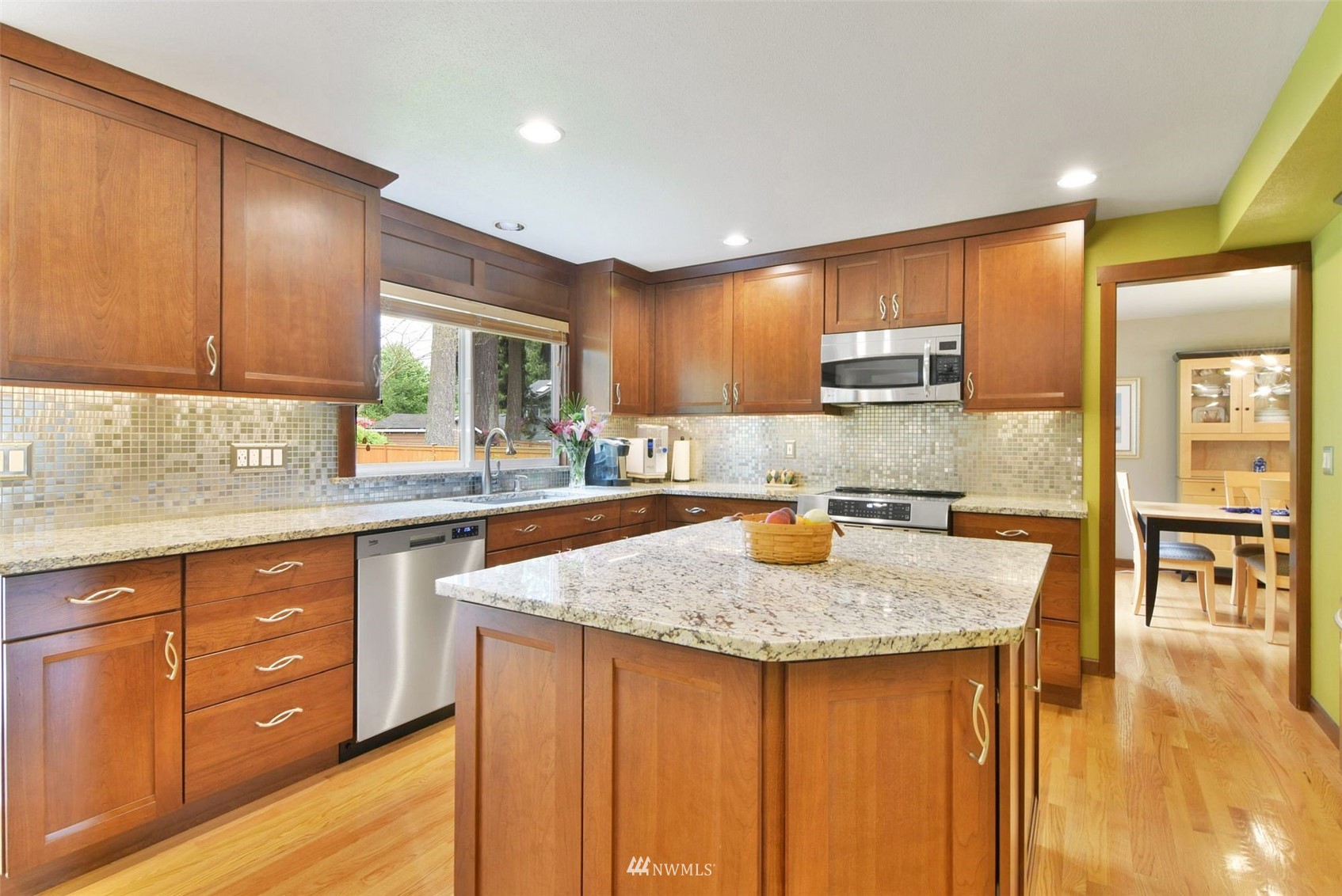 11810 37th Drive Southeast Everett, WA 98208 - Photo 6 of 28 a kitchen with kitchen island granite countertop wooden cabinets a sink and dishwasher