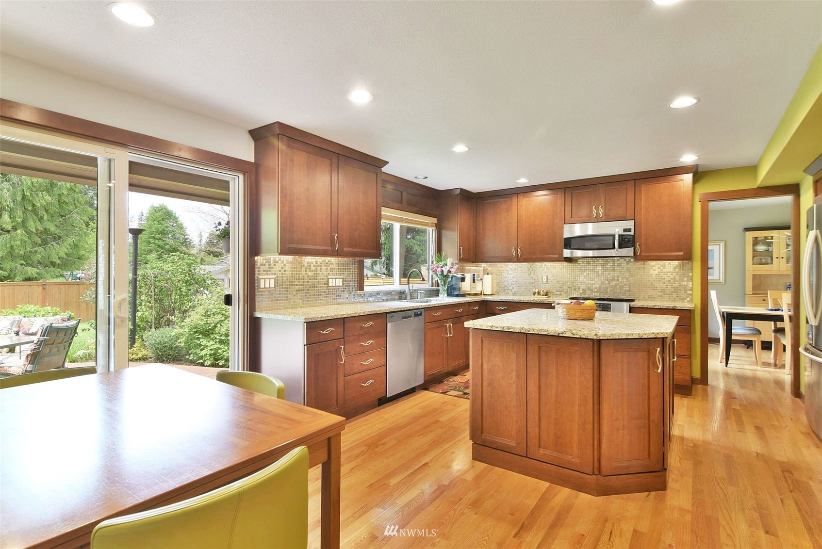 11810 37th Drive Southeast Everett, WA 98208 - Photo 7 of 28 a kitchen with kitchen island granite countertop wooden floors and wide window