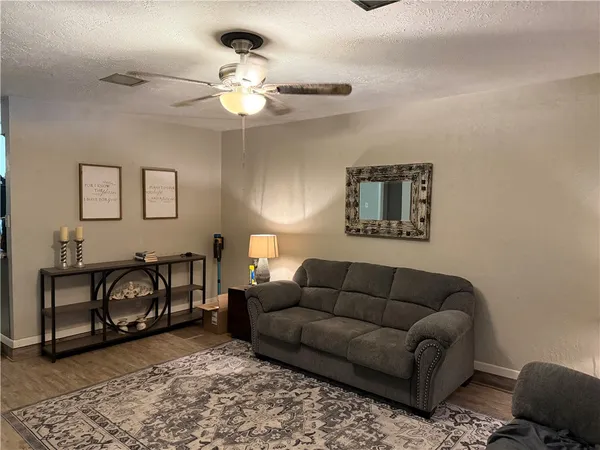 a living room with furniture a chandelier and a couch