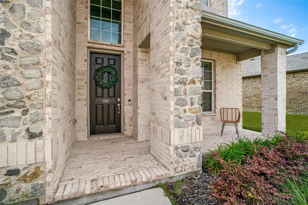 3115 Giovanni Point Princeton, TX 75407 - Photo 3 of 26 Brick and stone veneer exterior with a covered porch
