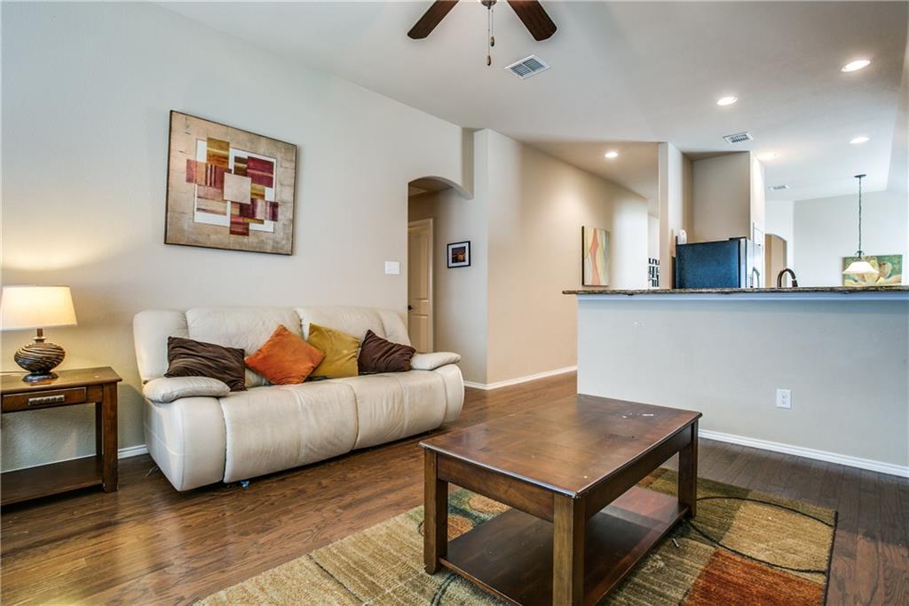 713 Setting Sun Trail McKinney, TX 75069 - Photo 13 of 25 a living room with furniture and a wooden floor