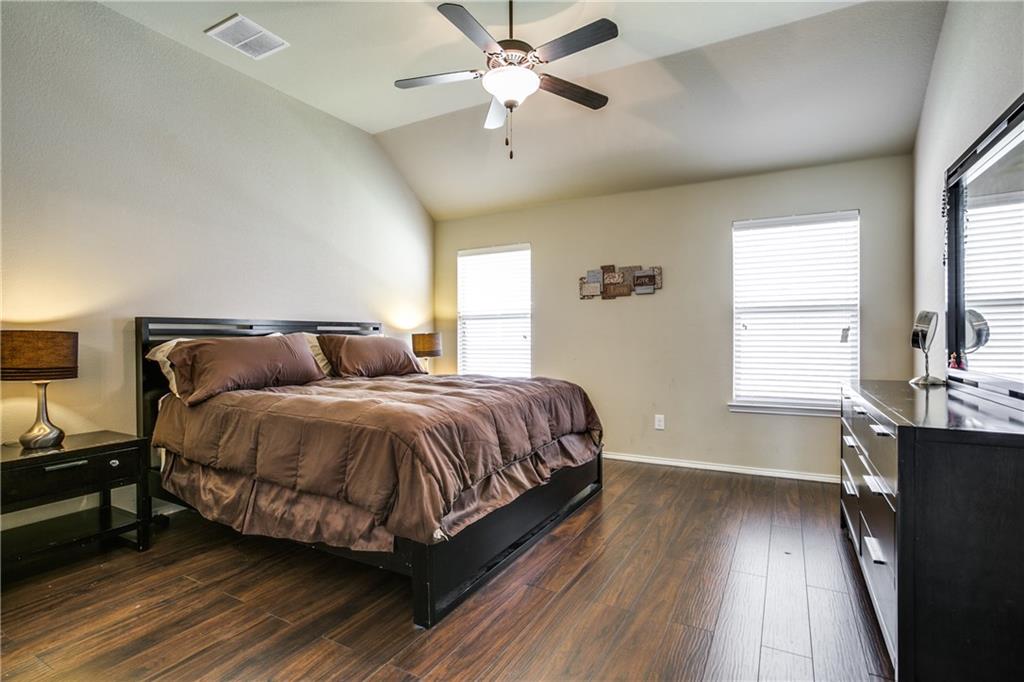 713 Setting Sun Trail McKinney, TX 75069 - Photo 16 of 25 a bedroom with a bed and wooden floor