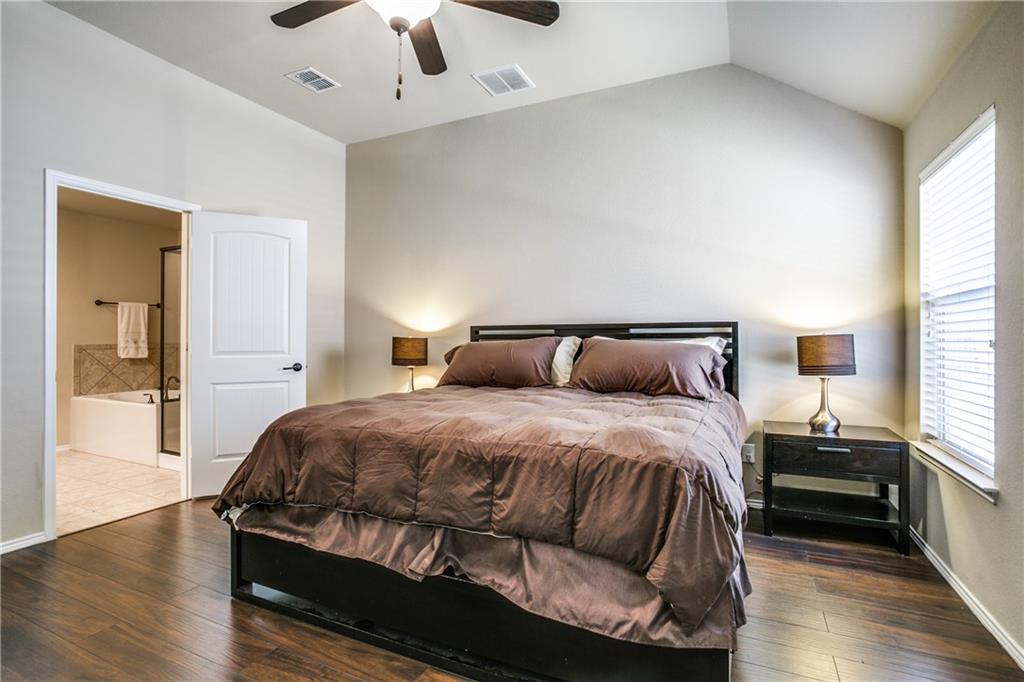713 Setting Sun Trail McKinney, TX 75069 - Photo 17 of 25 a bedroom with a bed and wooden floor