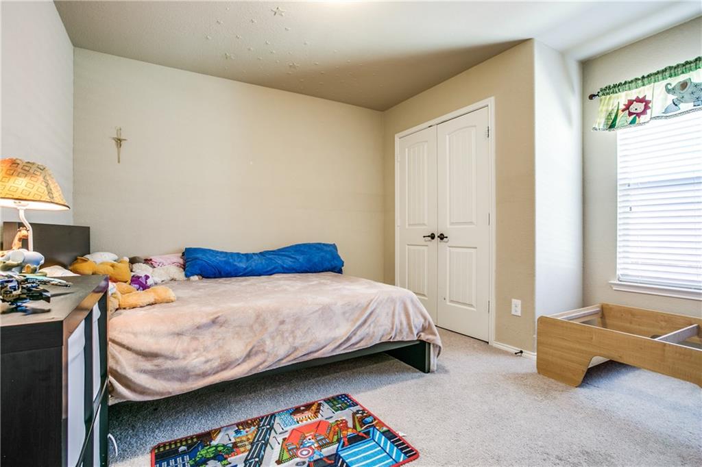 713 Setting Sun Trail McKinney, TX 75069 - Photo 21 of 25 a bedroom with a bed and a window