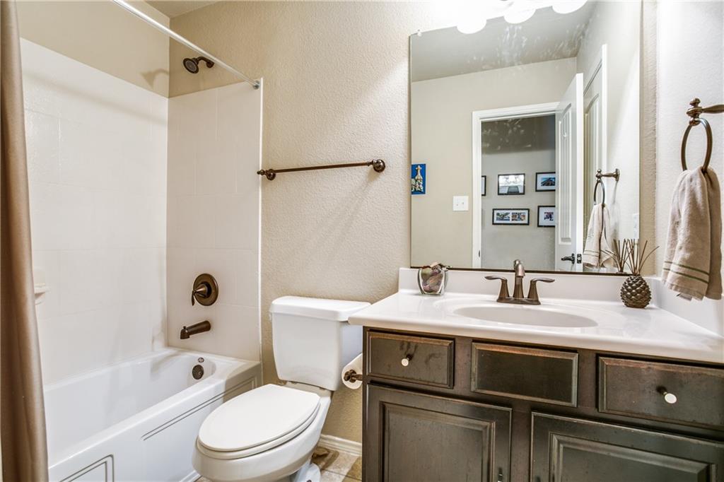 713 Setting Sun Trail McKinney, TX 75069 - Photo 22 of 25 a bathroom with a granite countertop sink toilet and shower