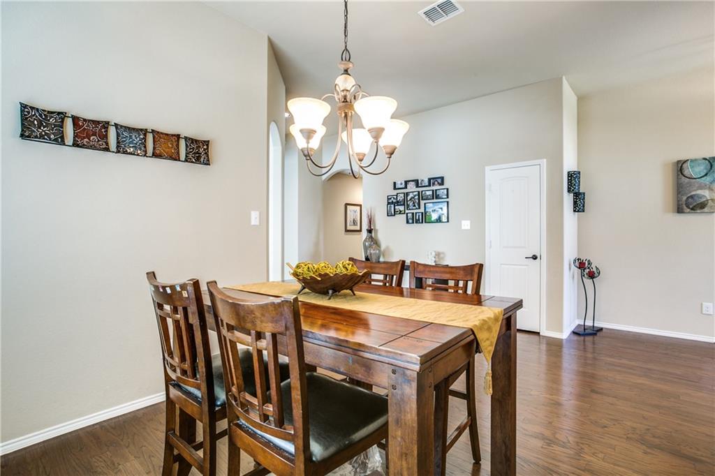 713 Setting Sun Trail McKinney, TX 75069 - Photo 5 of 25 a view of a dining room with furniture and wooden floor