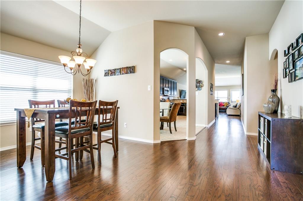 713 Setting Sun Trail McKinney, TX 75069 - Photo 7 of 25 a view of a dining room with furniture and wooden floor