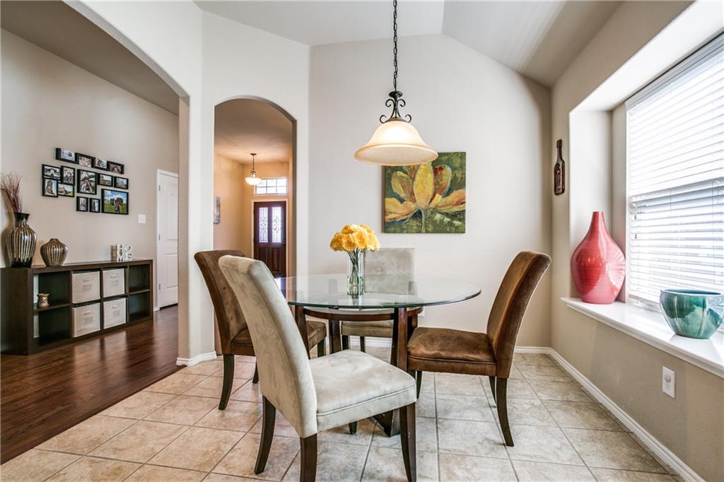713 Setting Sun Trail McKinney, TX 75069 - Photo 8 of 25 a view of a dining room with furniture and wooden floor