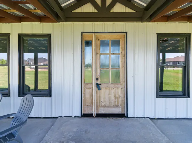 a view of a house with swimming pool and a yard