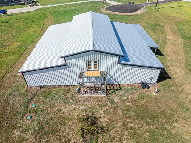 an aerial view of a houses with a yard