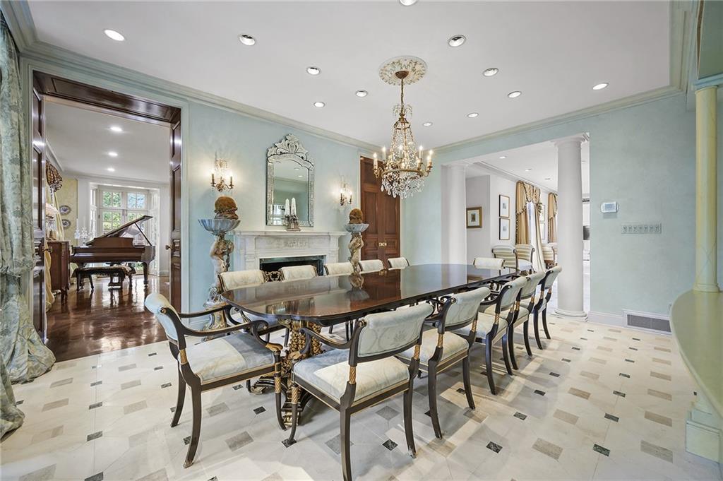 898 Persimmon Road Sewickley, PA 15143 - Photo 12 of 50 The dining room showcases classical proportions, detailed crown molding and a white marble fireplace anchors the room.