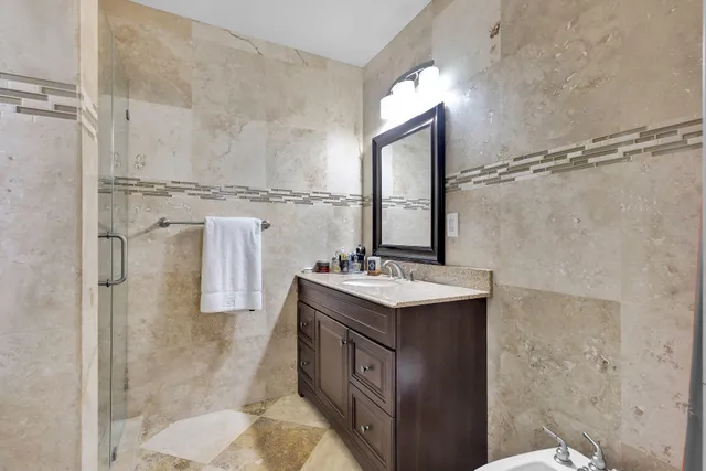 a bathroom with a sink a mirror and a shower