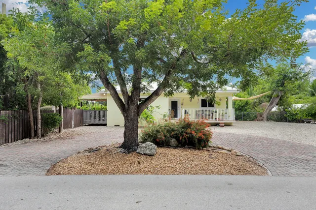 a view of a house with a tree