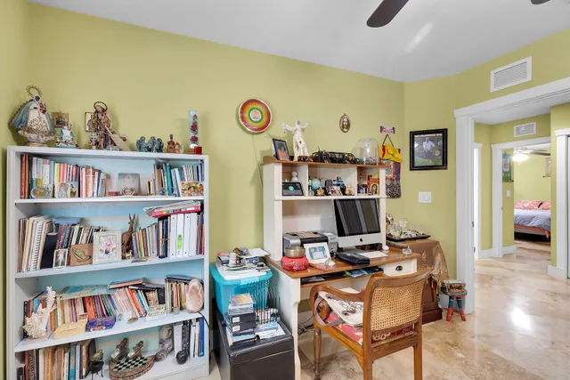 a view of a workspace with furniture and book shelf