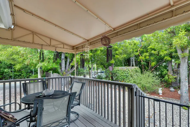 a view of a chair and table in the balcony