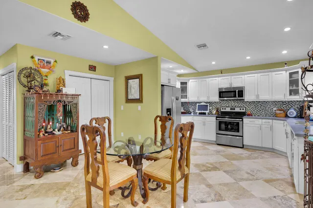 a view of kitchen with table and chairs