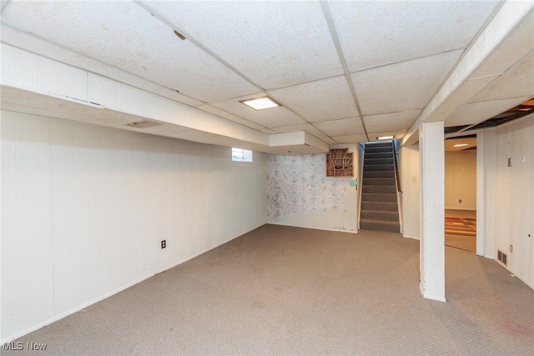 3801 Baird Road Stow, OH 44224 - Photo 23 of 31 Below grade area with carpet floors, a drop ceiling, and stairway