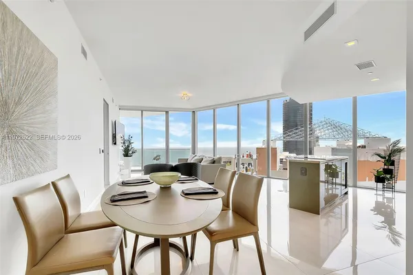 a bedroom with a large bed and a large window