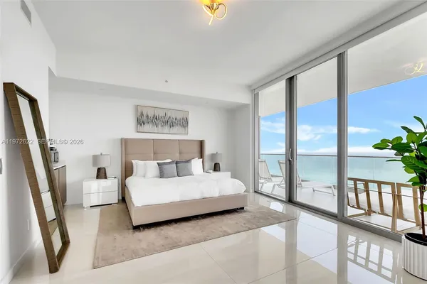 a bedroom with a bed and large window