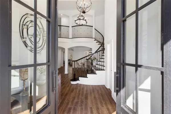 a view of entryway and hall with wooden floor