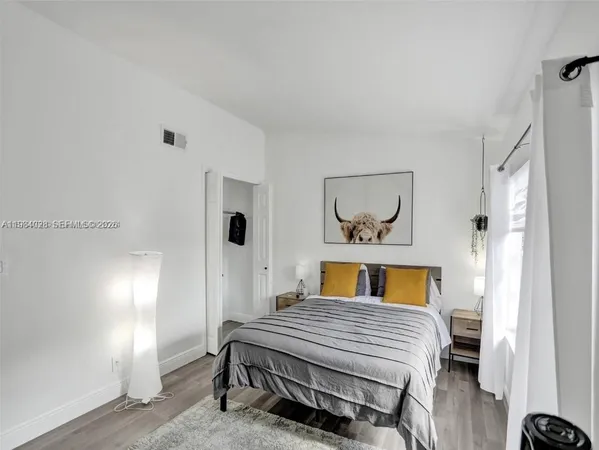 a bedroom with a bed and a mirror