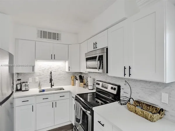 a kitchen with a sink stove and cabinets