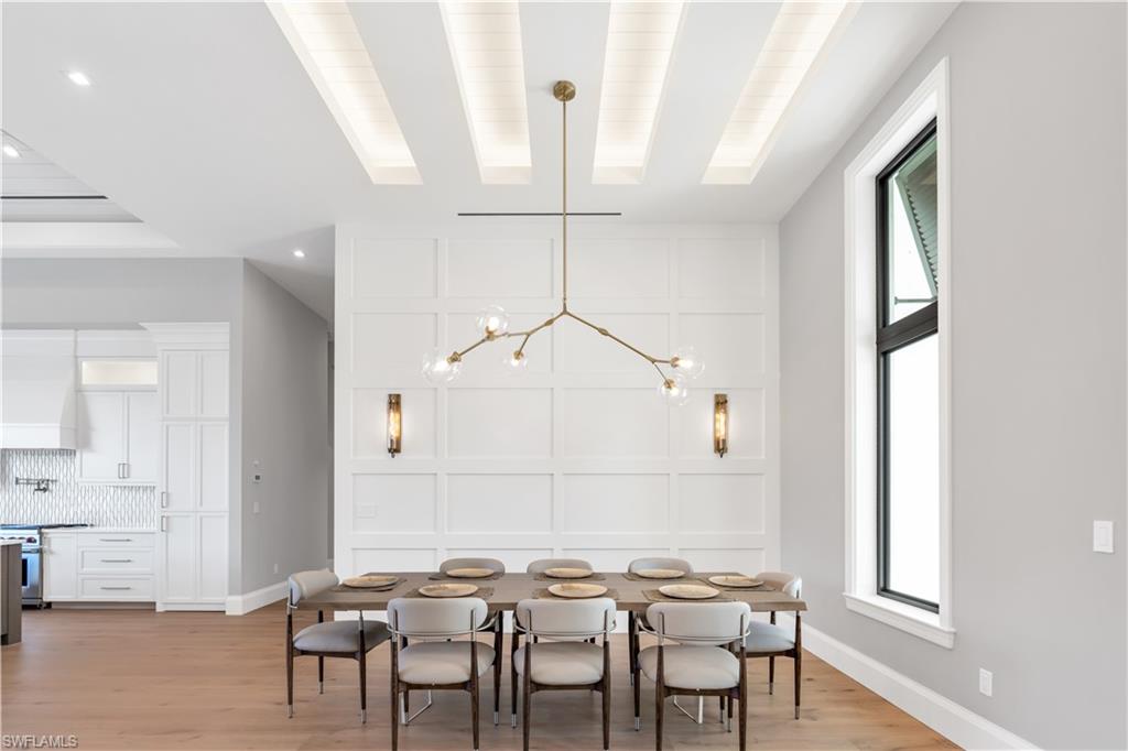 635 Harbour Drive Naples, FL 34103 - Photo 11 of 32 a view of a dining room with furniture and wooden floor