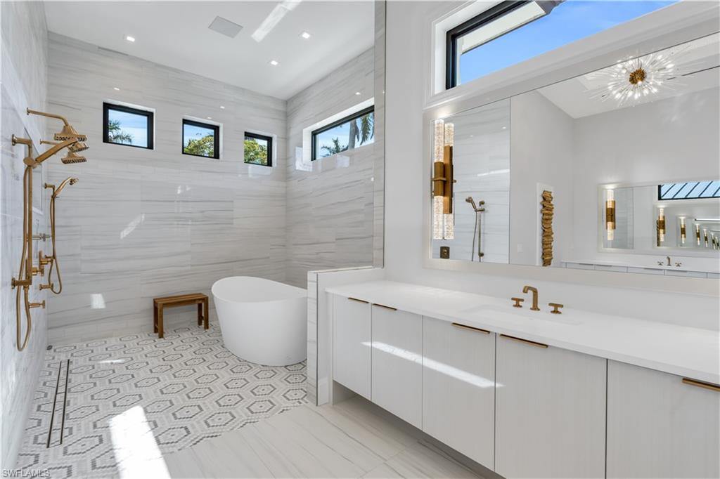 635 Harbour Drive Naples, FL 34103 - Photo 16 of 32 a bathroom with a sink a toilet and mirror