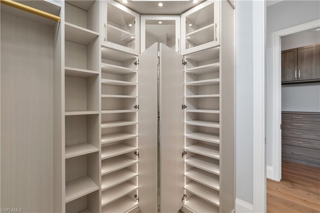 635 Harbour Drive Naples, FL 34103 - Photo 18 of 32 a view of walk in closet with empty racks