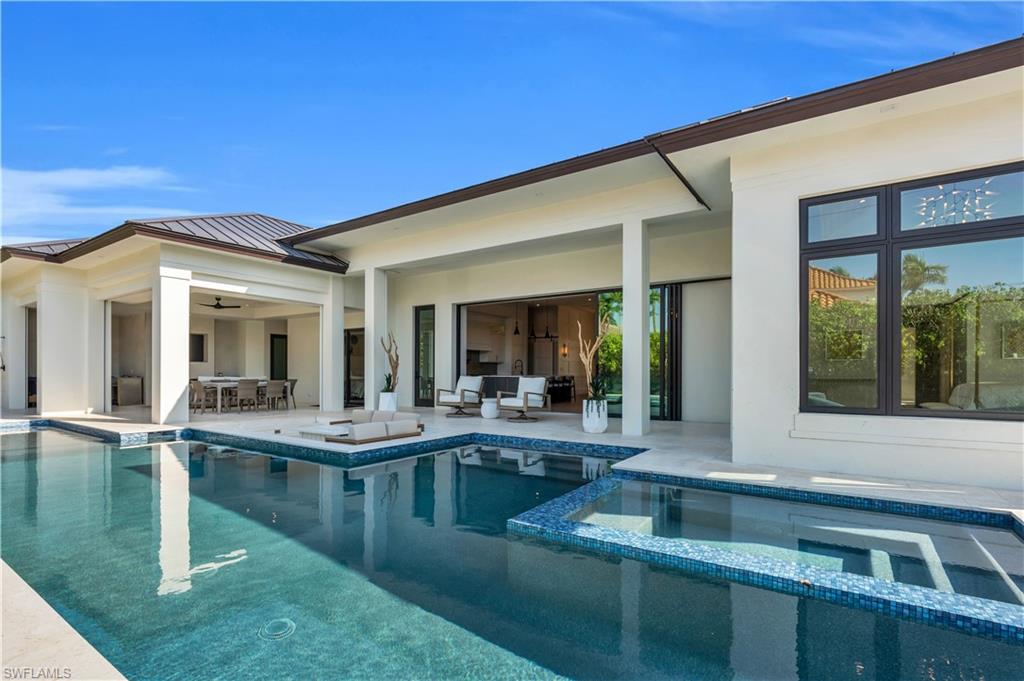 635 Harbour Drive Naples, FL 34103 - Photo 20 of 32 a view of house with pool and outdoor seating