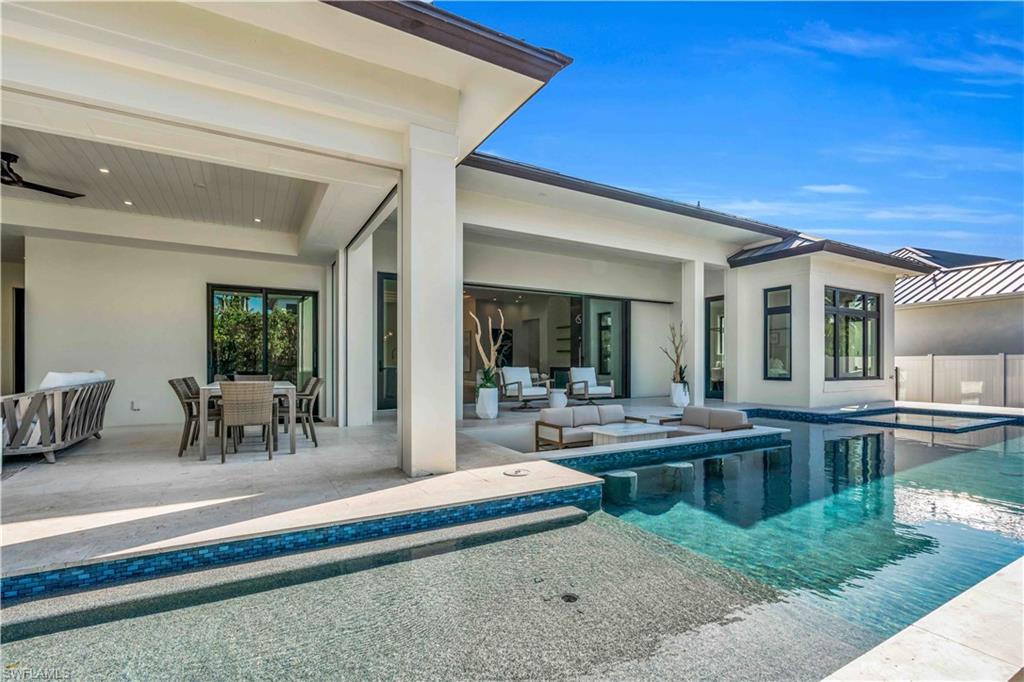 635 Harbour Drive Naples, FL 34103 - Photo 21 of 32 a living room with furniture a dining table and a large window