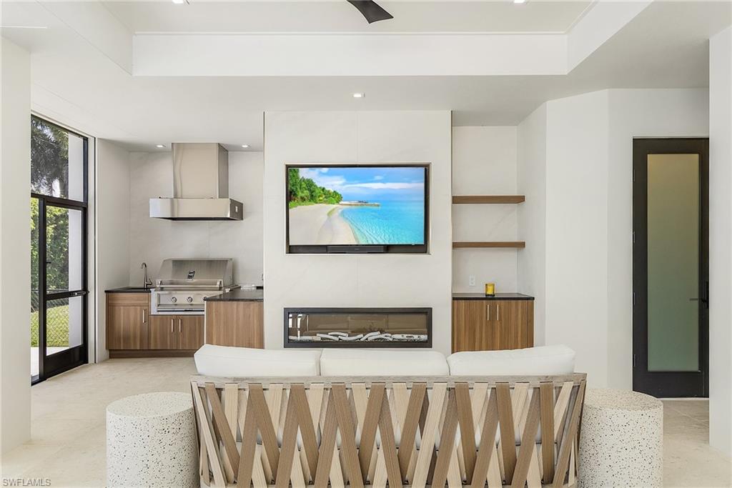 635 Harbour Drive Naples, FL 34103 - Photo 22 of 32 a kitchen with stainless steel appliances granite countertop a stove a sink and a refrigerator