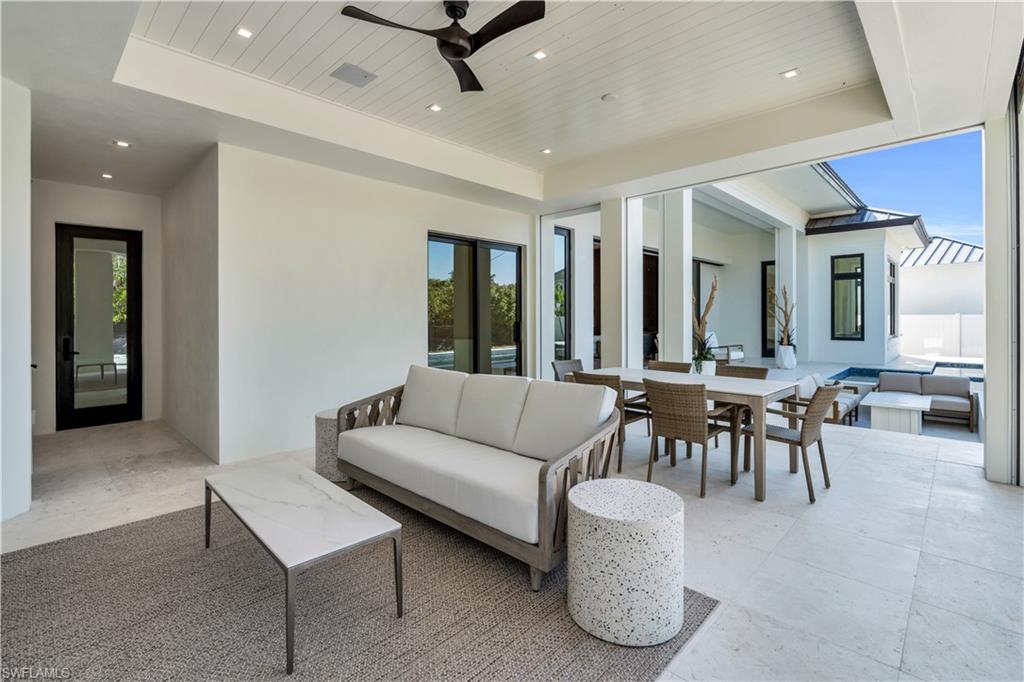 635 Harbour Drive Naples, FL 34103 - Photo 23 of 32 a living room with furniture and a large window
