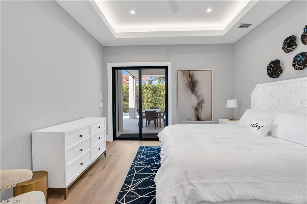 635 Harbour Drive Naples, FL 34103 - Photo 27 of 32 a spacious bedroom with a bed and a window