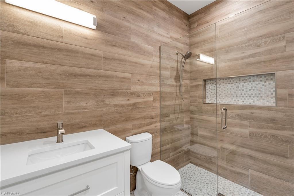 635 Harbour Drive Naples, FL 34103 - Photo 28 of 32 a bathroom with a toilet sink and shower