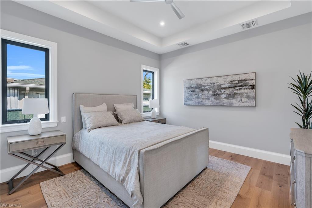 635 Harbour Drive Naples, FL 34103 - Photo 30 of 32 a bedroom with a large bed and a painting on the wall