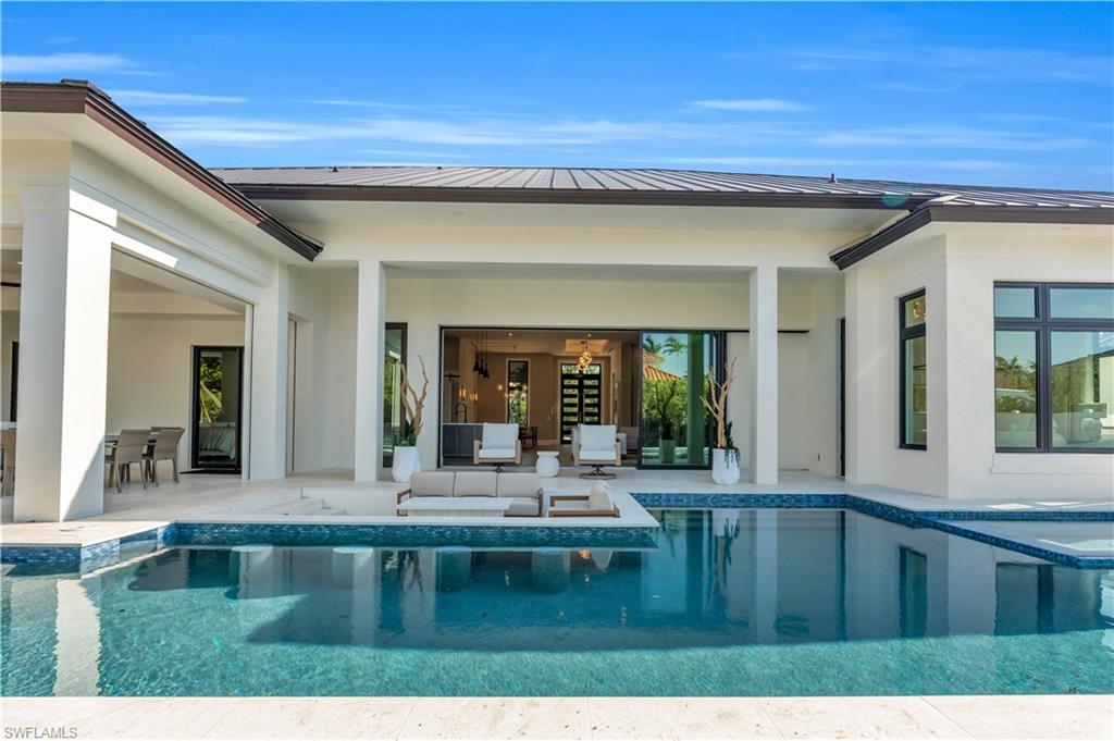 635 Harbour Drive Naples, FL 34103 - Photo 3 of 32 a bathroom with a sink and a large window