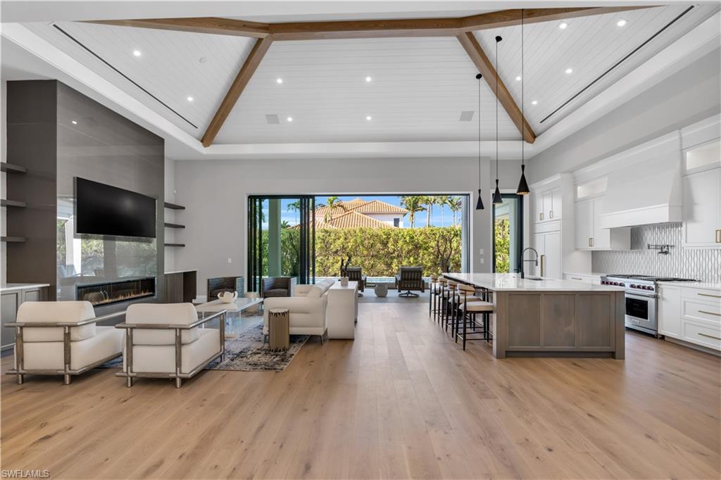 635 Harbour Drive Naples, FL 34103 - Photo 4 of 32 a living room with furniture and a flat screen tv
