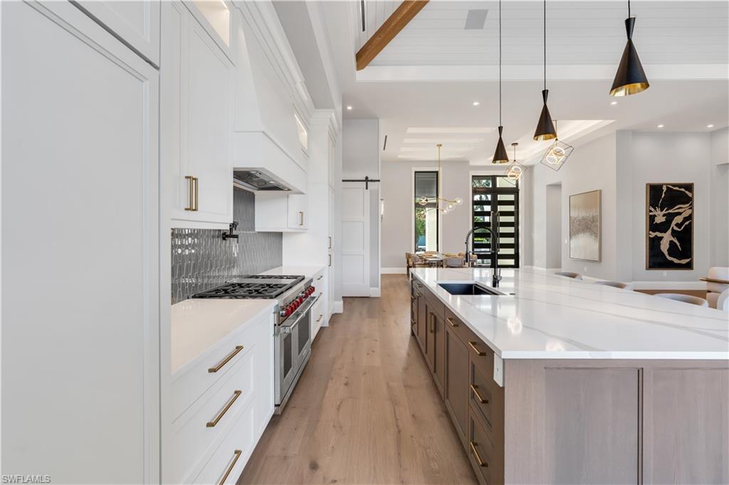 635 Harbour Drive Naples, FL 34103 - Photo 8 of 32 a kitchen with stainless steel appliances kitchen island a stove and a sink
