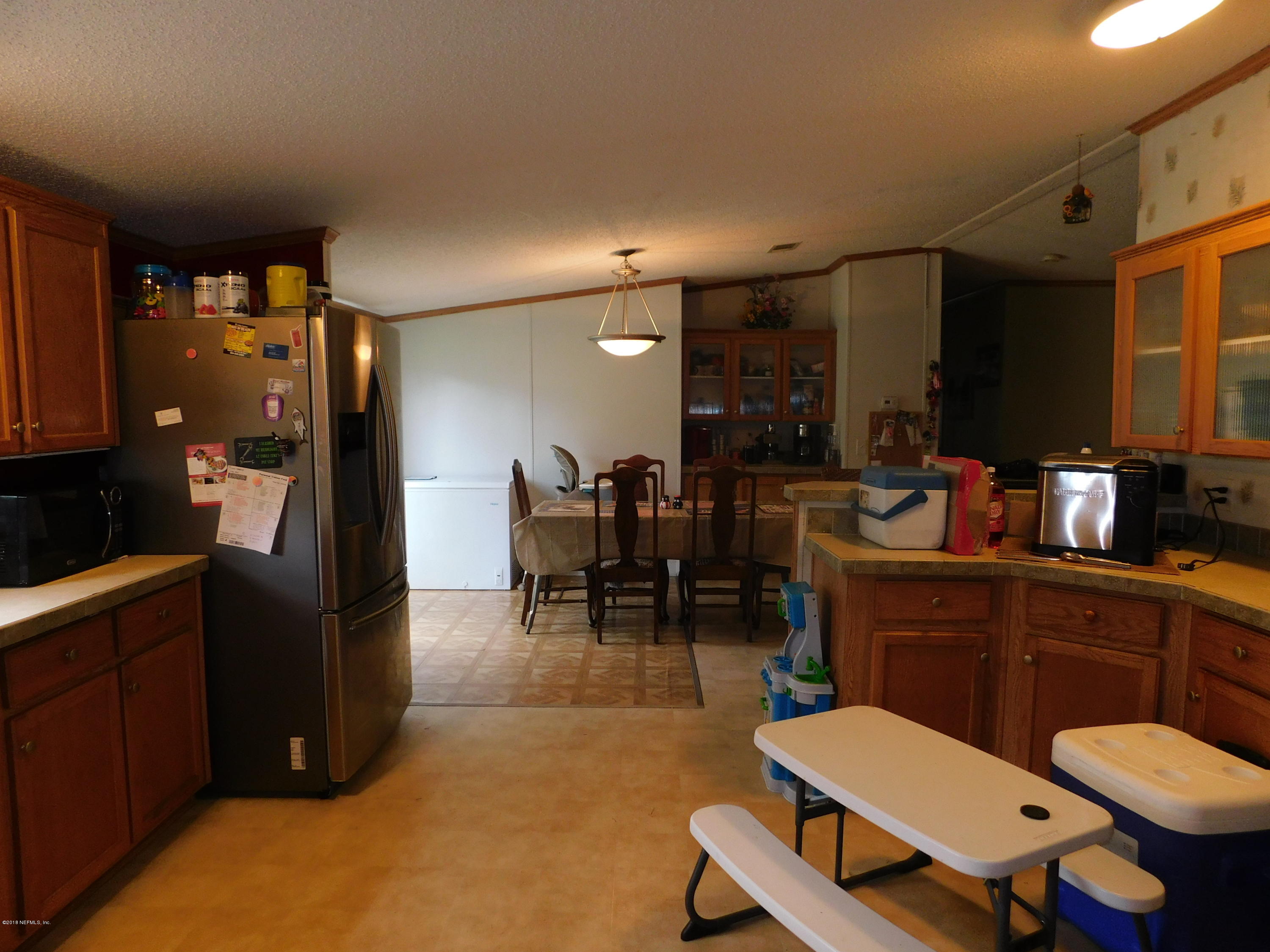45247 Eula B Road Callahan, FL 32011 - Photo 7 of 24 a kitchen with a sink cabinets and dining table