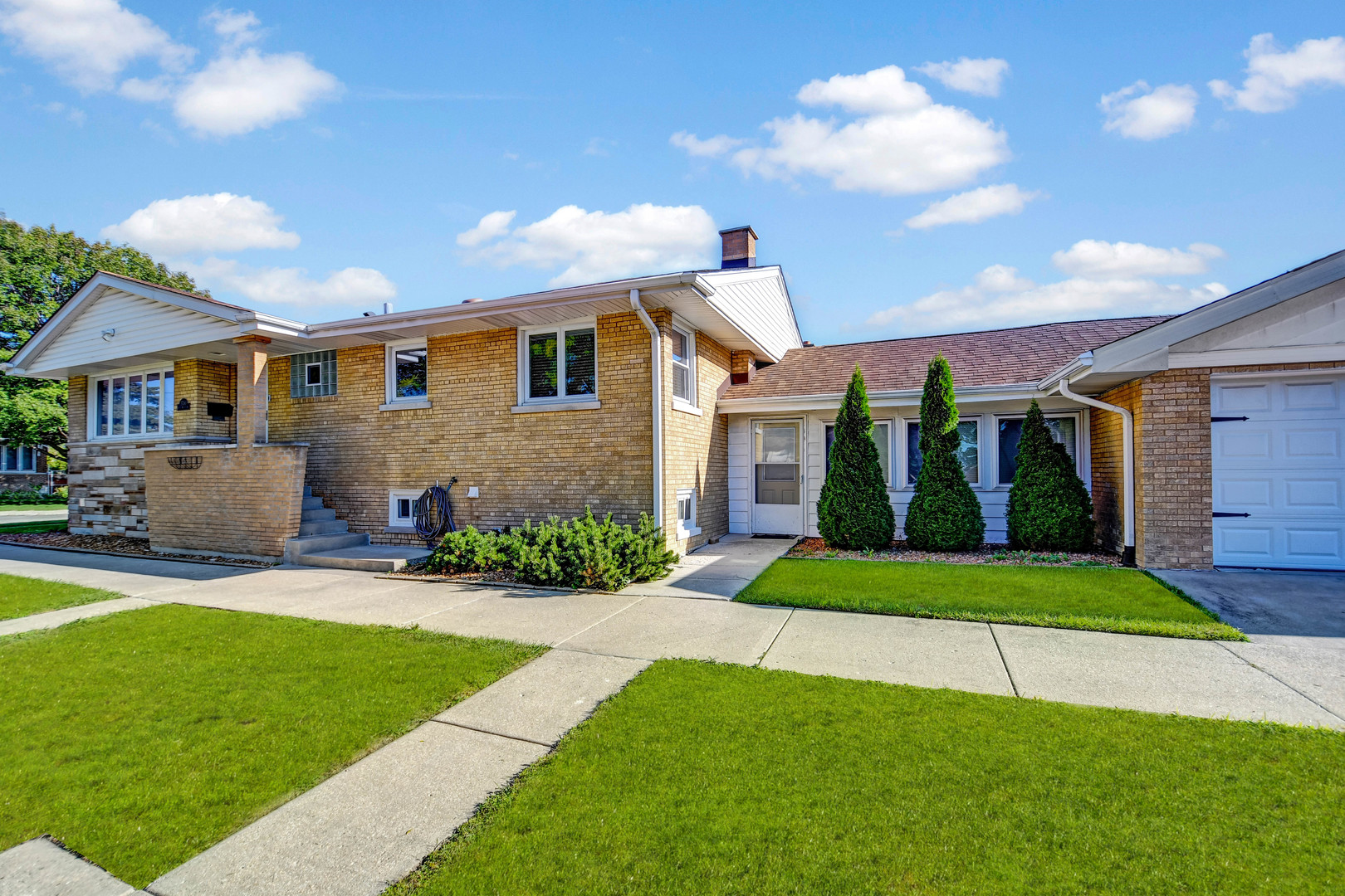 5700 South Monitor Avenue Chicago, IL 60638 - Photo 19 of 22 a front view of a house with a yard and garage