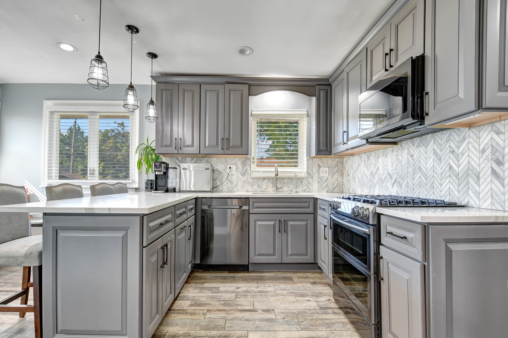 5700 South Monitor Avenue Chicago, IL 60638 - Photo 5 of 22 a kitchen with granite countertop sink stainless steel appliances and window
