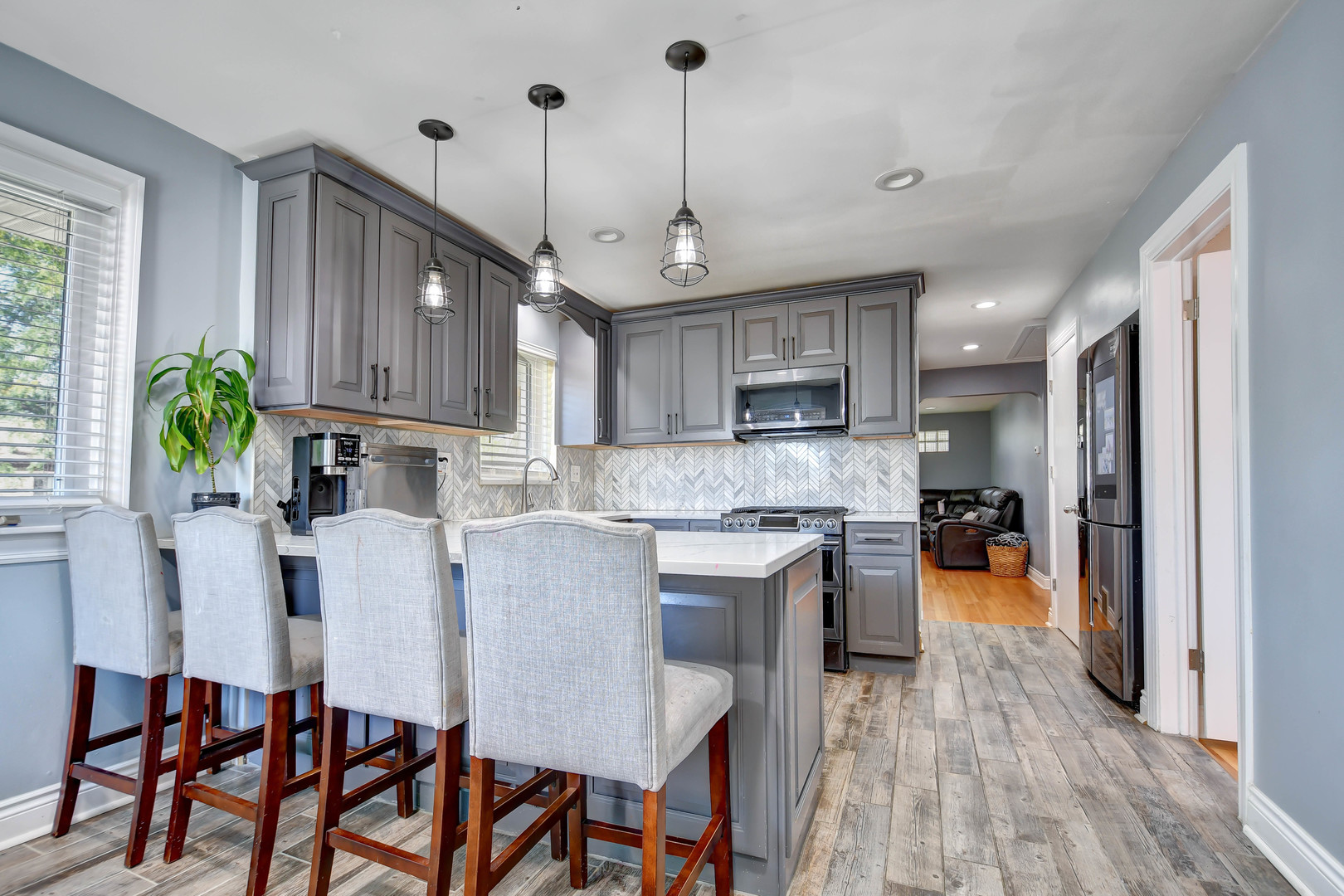 5700 South Monitor Avenue Chicago, IL 60638 - Photo 6 of 22 a kitchen with stainless steel appliances granite countertop a stove top oven a refrigerator a sink and a dining table with wooden floor