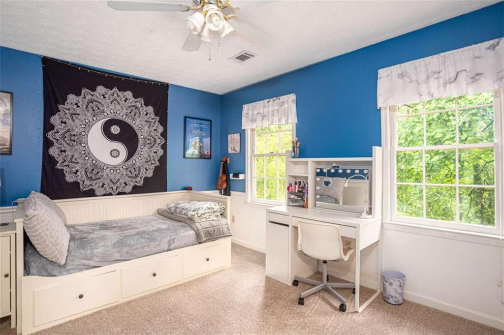3838 Hunting Ridge Drive Southwest Lilburn, GA 30047 - Photo 36 of 56 a bedroom with a bed and a large window
