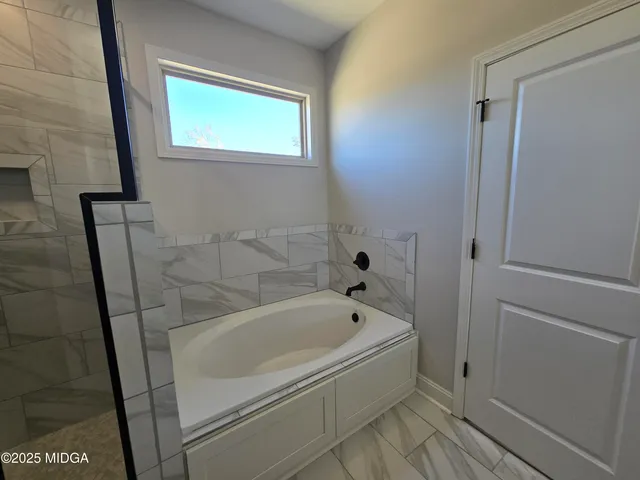 a white bath tub sitting next to a window
