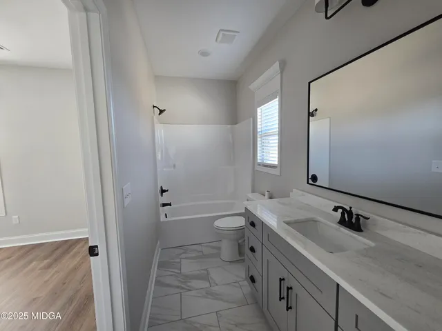 a bathroom with a granite countertop sink mirror and double