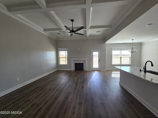 a view of an empty room with a fireplace and a window