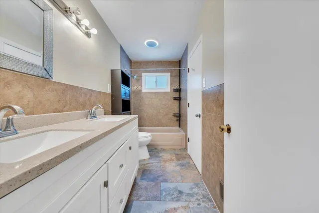 a bathroom with a sink toilet and vanity