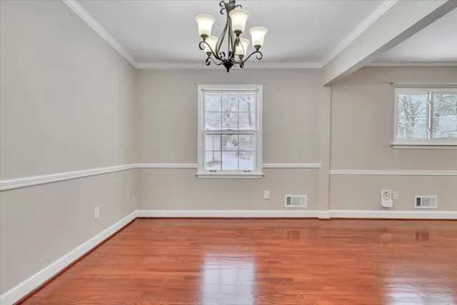 a spacious bathroom with a double vanity sink a toilet and a large mirror